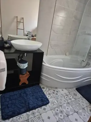 a bathroom with a sink and a toilet and a tub at Chambre meublé Eden à Noves in Noves