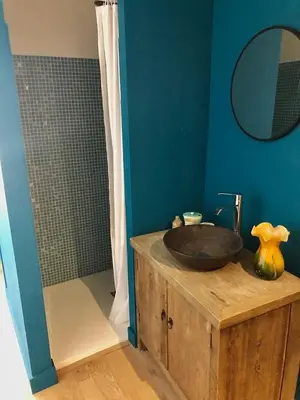 a bathroom with a sink on top of a wooden cabinet at Charming house in Provence, 2 to 10 people in Saignon