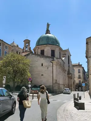 two women walking down a street in front of a building at Charming house in Provence, 2 to 10 people in Saignon