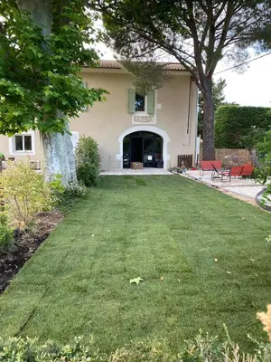 a yard in front of a house with a lawn at Gîte dans un mas Provençal - L'Oustalet in Saint-Andiol