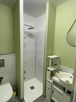 a white bathroom with a shower and a sink at Gîte dans un mas Provençal - L'Oustalet in Saint-Andiol