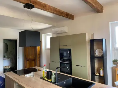 a kitchen with a sink and a stove top oven at Gîte dans un mas Provençal - L'Oustalet in Saint-Andiol