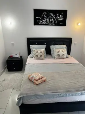 a bedroom with a large bed with a black headboard at Chambre d'hôtes in Carpentras