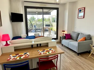 a living room with a couch and a table at Ma place au sud 216 in Éguilles