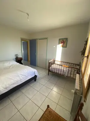 a bedroom with a bed and a tiled floor at Villa de l'Argau in Revest-du-Bion