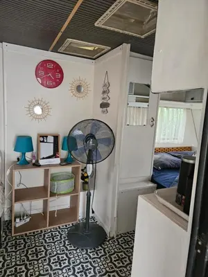 a room with a fan in a tiny house at Escapade en caravane près d'aix en provence in Meyreuil