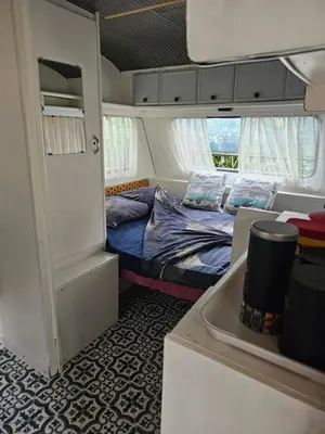 a small bedroom with a bed in a tiny house at Escapade en caravane près d'aix en provence in Meyreuil