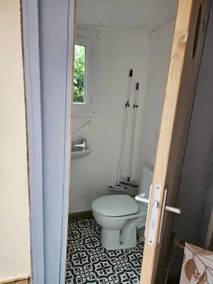 a small bathroom with a toilet and a window at Escapade en caravane près d'aix en provence in Meyreuil