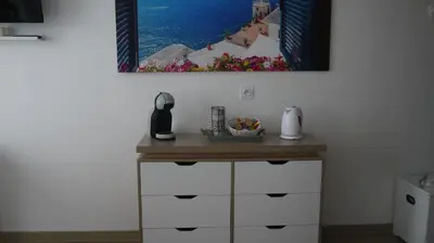 a kitchen with a table with a picture on the wall at Studio Business Wi-Fi 7 TVA Proche zones LesMilles La Duranne Aix TGV in Éguilles