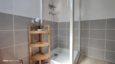a shower with a wooden shelf in a bathroom at Studio Business Wi-Fi 7 TVA Proche zones LesMilles La Duranne Aix TGV in Éguilles