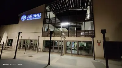 a building with a sign on the side of it at Studio Business Wi-Fi 7 TVA Proche zones LesMilles La Duranne Aix TGV in Éguilles