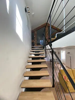 a staircase in a house with wooden steps and a window at Les Tilleuls in Bonnieux