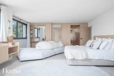 two beds in a bedroom with white furniture at Domaine Bellevue Ste-Victoire View Pools & Cinema in Le Puy-Sainte-Réparade