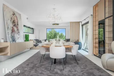 a dining room and living room with a table and chairs at Domaine Bellevue Ste-Victoire View Pools & Cinema in Le Puy-Sainte-Réparade