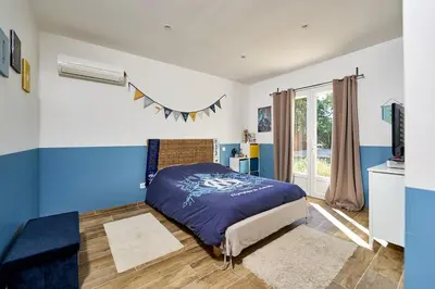 a bedroom with blue and white walls and a bed at Maison au calme proche Mont Ventoux et Luberon in Malemort-du-Comtat