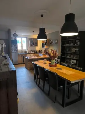 a kitchen with a large wooden table and chairs at Gîte en Provence in Cavaillon