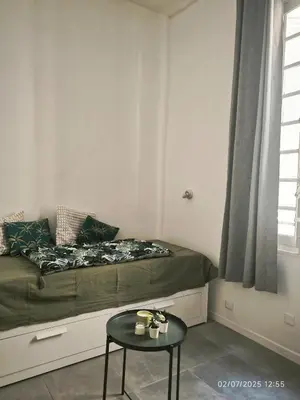 a kitchen with a table and two chairs and a sink at New - studio avec clim au centre d'Aix 2eme étage in Aix-en-Provence