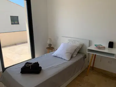 a small bedroom with a bed with a window at Villa MTI Ventoux in Blauvac