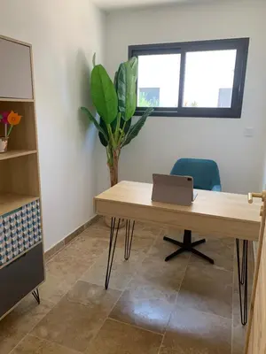 an office with a wooden desk with a laptop on it at Villa MTI Ventoux in Blauvac