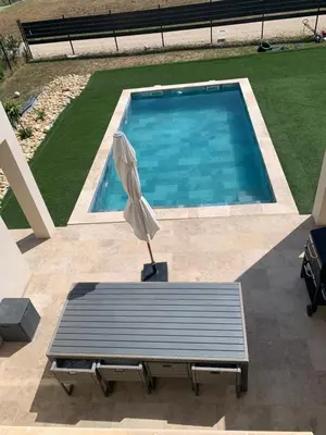 an umbrella sitting on a bench next to a swimming pool at Villa MTI Ventoux in Blauvac