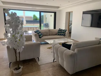 a living room with couches and a tv and a tree at Villa MTI Ventoux in Blauvac