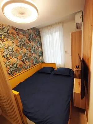a bed in a small room with a wall at Studio plein centre Aix-en-Provence in Aix-en-Provence