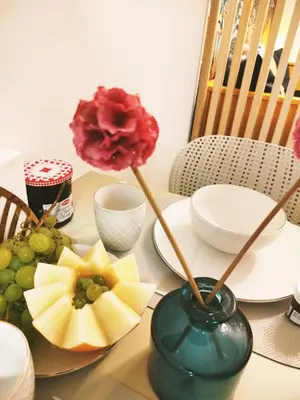 a table with a vase with a flower on it at Studio plein centre Aix-en-Provence in Aix-en-Provence