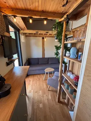 a living room with a blue couch in a tiny house at La Tiny du Luberon in Pertuis