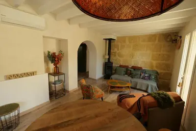 a living room with a couch and a table at Maison 2 ch en campagne 5 mn du centre en voiture avec possibilité piscine familiale in Salon-de-Provence
