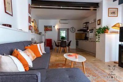 a living room with a blue couch and a table at Un Loft en Luberon à Bonnieux in Bonnieux