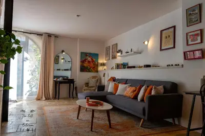 a living room with a blue couch and a table at Un Loft en Luberon à Bonnieux in Bonnieux
