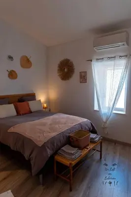 a bedroom with a large bed and a window at Un Loft en Luberon à Bonnieux in Bonnieux