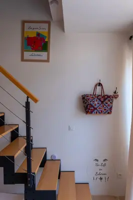 a staircase in a house with a purse on the wall at Un Loft en Luberon à Bonnieux in Bonnieux