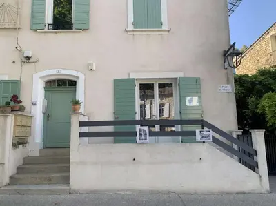 a house with a green door and stairs in front at Le Yodala - Lamanon in Lamanon