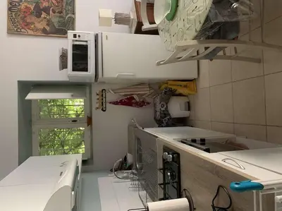 a kitchen with a microwave and a stove top oven at Le Yodala - Lamanon in Lamanon