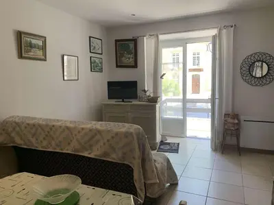 a room with a bed and a television and a table at Le Yodala - Lamanon in Lamanon