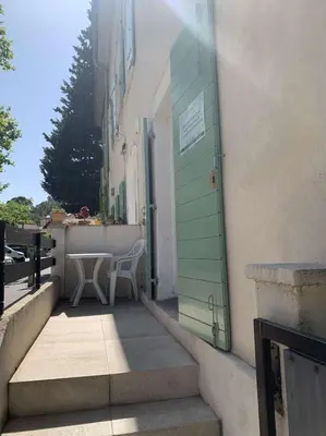 a door to a building with a table and a chair at Le Yodala - Lamanon in Lamanon