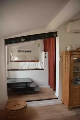 a bedroom with a large mirror above a bed at Large studio with terrace and air conditioning in Aix-en-Provence