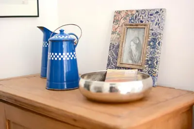 a blue pitcher and a bowl on a wooden table at Large studio with terrace and air conditioning in Aix-en-Provence