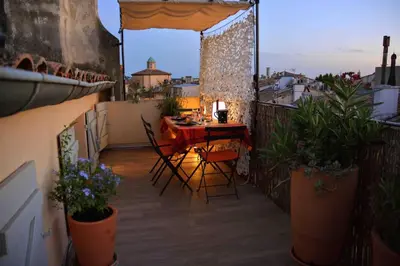 a patio with a table and chairs on a balcony at Large studio with terrace and air conditioning in Aix-en-Provence