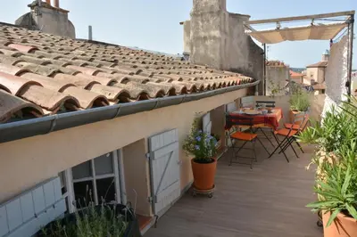a balcony with a table and chairs on a building at Large studio with terrace and air conditioning in Aix-en-Provence