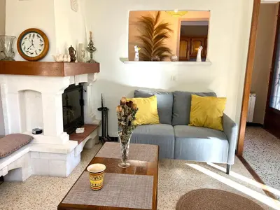 a living room with a blue couch and a fireplace at La maison aux oiseaux - Luberon in Oppède