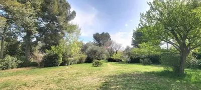 a garden with trees and grass and a field at Appartement au calme à 5min du centre d'Aix-en-Provence avec terrasse vue sur jardin & parking privé in Aix-en-Provence