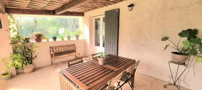 an outdoor patio with a bench and potted plants at Appartement au calme à 5min du centre d'Aix-en-Provence avec terrasse vue sur jardin & parking privé in Aix-en-Provence
