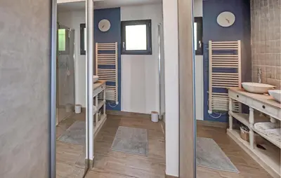 a bathroom with two sinks and two mirrors at Maison Avec Piscine Privée in Monteux