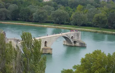 a group of people crossing a bridge over a river at Maison Avec Piscine Privée in Monteux