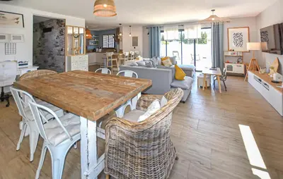 a kitchen and living room with a table and chairs at Maison Avec Piscine Privée in Monteux