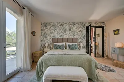 a bedroom with a bed and a large window at La Villa KEF - Domaine & Golf de Pont Royal in Mallemort