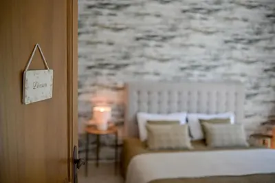 a bedroom with a bed with pillows and a wall at La Villa KEF - Domaine & Golf de Pont Royal in Mallemort