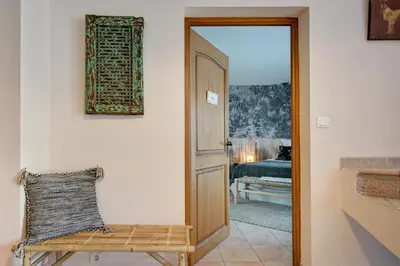 a door leading into a room with a chair at La Villa KEF - Domaine & Golf de Pont Royal in Mallemort